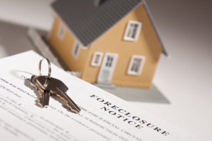 Foreclosure Notice, House Keys and Model Home on Gradated Background with Selective Focus.