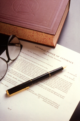 Book, pen and Power of Attorney document on a desktop